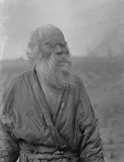 Aino Prints: Ainu man standing outside, 1908. Creator: Arnold Genthe