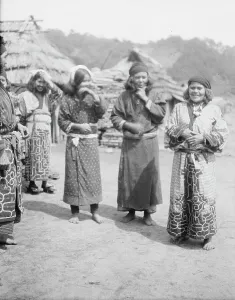 Ainu woman outside in the village lane, 1908. Creator: Arnold Genthe