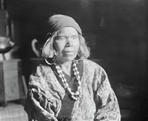 Ainu woman wearing a headscarf, earrings, and a necklace, 1908. Creator: Arnold Genthe