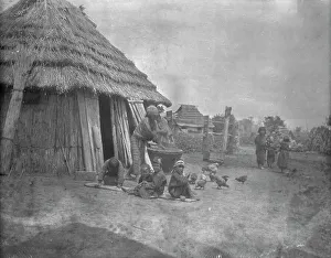 Aino Prints: Ainu women and children outside a hut, 1908. Creator: Arnold Genthe