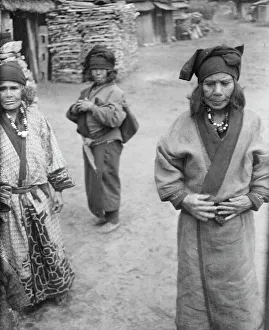 Aino Prints: Three Ainu women outside in the village lane, 1908. Creator: Arnold Genthe