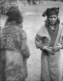 Two Ainu women in the village lane, 1908. Creator: Arnold Genthe