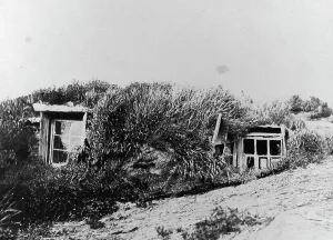 Covered Prints: An Aleut house, which is a hole in the earth covered with a framework of driftwood