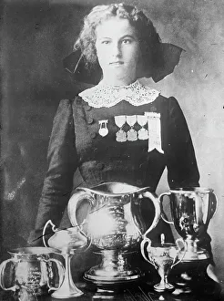 Trophies Prints: Alsie Aykroyd in front of her trophies, 1910. Creator: Bain News Service