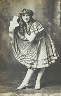 Bending Prints: An amateur actor in drag holds up his impressive folded dress to one side