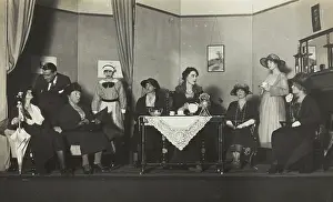 Amateur actors, some in drag, are having tea on stage, [between 1920 and 1929?]. Creator: Unknown