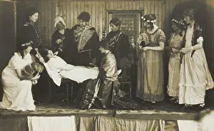 Cross Dressing Prints: Amateur actors, some in drag, on stage attending to the death of a female character