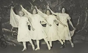 Cross Dressing Prints: Amateur actors in drag, wearing white dresses and dancing on stage