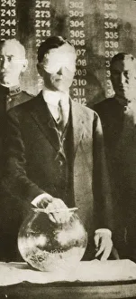 Draft Prints: American Secretary of War Newton D Baker drawing the first number in the selective draft