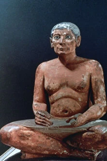 Ancient Egyptian figure of a seated scribe, 25th-24th century BC
