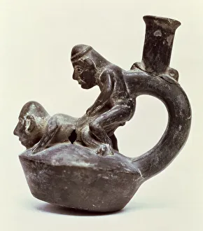 Anthropomorphic Vase with stirrup handle depicting two male persons performing a sex act