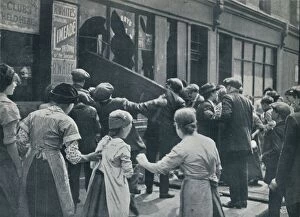 Plundering Gallery: Anti-German rioting in London: A crowd breaking in the windows of a German shop, c1914