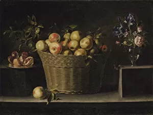 Images Dated 19th June 2013: Apples in a wicker basket, an pomegranate on a silver plate and flowers in a glass vase