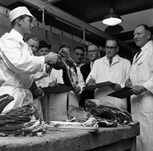 Apprentice butcher showing his work to competition judges, Barnsley, South Yorkshire, 1963