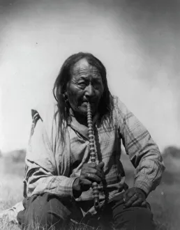 Arapaho Prints: Arapaho Indian smoking pipe, c1910. Creator: Edward Sheriff Curtis