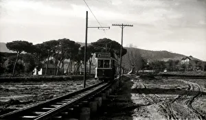 Argentona Mataro Tram crossing the pontoon on the river of Argentona, on a postcard