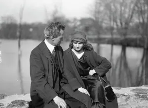 Social Life Prints: Arnold Genthe seated outdoors with a woman friend