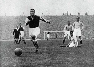 Action Prints: Arsenal footballer Alex James passes three Manchester City players