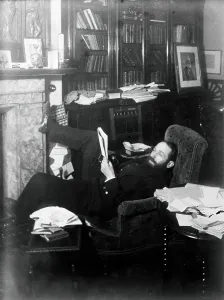 Paperwork Prints: Arthur Schuster, lying on an armchair by a fireplace
