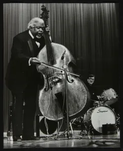 Satchmo Prints: Arvell Shaw and Barrett Deems on stage, Stevenage, Hertfordshire, 1984