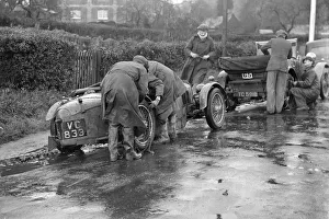 Attaching snow chains to JE Lancasters Riley Brooklands during the Inter-Varsity Trial, 1930