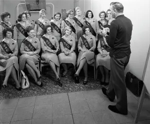 Food Industry Prints: Australian sales girls with SPL sashes listen to a sales talk