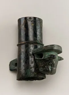 Axle cap with linchpin cast in the form of a feline head, Zhou dynasty, 1050-221 BCE Axle cap with linchpin cast in the form of a feline head, Zhou dynasty, 1050-221 BCE