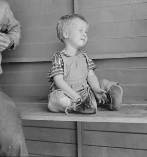 Displaced People Gallery: Baby with club feet wearing homemade splints, FSA camp, Tulare County, California, 1939