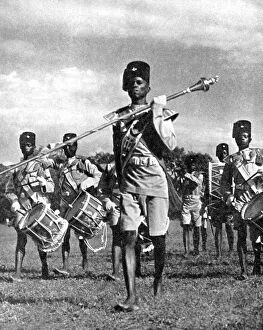 Peoples Of The World In Pictures Gallery: Bandsmen of the Northern Rhodesia Regiment beat a military tattoo, Zimbabwe, Africa