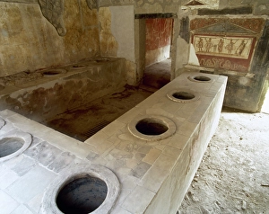 Bar counter with holes to place the amphorae, Thermopolium of Asellina, Pompeii, Italy (2002). Creator: LTL