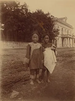 Muddy Prints: Two barefoot children standing in muddy street in front of the Lindholm's large
