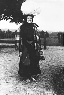 Vendor Prints: Barefoot woman carrying a sack on her head