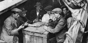 A bargee and his mates play dominoes in the hold of a canal boat, 1926-1927 A bargee and his mates play dominoes in the hold of a canal boat, 1926-1927