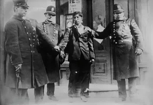 Injustice Prints: Battered striker with policemen, Philadelphia, 1910. Creator: Bain News Service