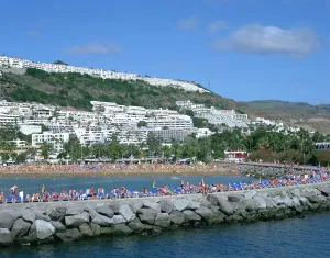 Sunbathing Prints: Beach and breakwater, Puerto Rico, Gran Canaria, Canary Islands