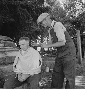 Bean pickers barber each other, near West Stayton, Marion County, Oregon, 1939. Creator: Dorothea Lange
