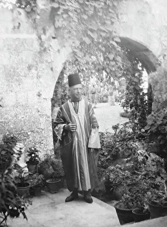 Tarboosh Prints: Benetti, Franco, Mr. standing outdoors, 1929 Creator: Arnold Genthe