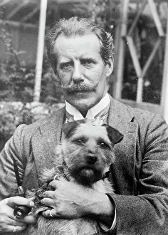 Bernard M. Partridge holding dog, 1910. Creator: Bain News Service