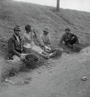Buckets Prints: Berry pickers at 5 am, waiting for the truck to haul them to work