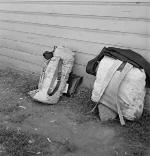 Homeless Collection: Bindles on shady side of Pastime Cafe, Tulelake, Siskiyou County, California, 1939
