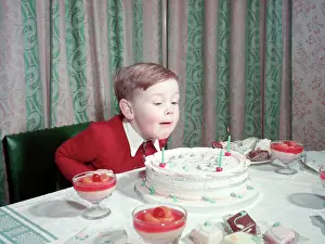 Blowing Prints: Birthday boy blowing out the candles on his cake