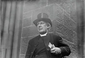 Dog Collar Prints: Bishop of Salisbury holding glasses and train schedule, 1910. Creator: Bain News Service