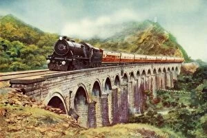 Cecil J Allen Collection: Between Bombay and Delhi. A striking view of the Frontier Mail passing over a viaduct