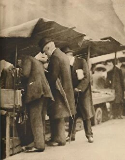 Lunchbreak Collection: At One of the Bookstalls of the Farringdon Road Market, c1935. Creator: Walter Benington