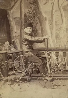 Tricycle Prints: A boy on a bicycle in a photo studio, 1880. Creator: Unknown