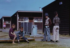 Toys Collection: Boy building a model airplane while other children look on, FSA labor camp, Robstown, Tex. 1942