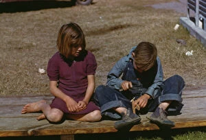 Boy building a model airplane as girl watches, FSA ... camp, Robstown, Tex., 1942. Creator: Arthur Rothstein
