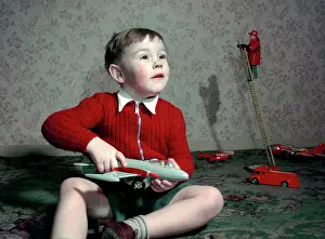 Ladder Prints: Boy playing with a toy aeroplane, c1960s. Creator: Arthur Charles Kirby Ware