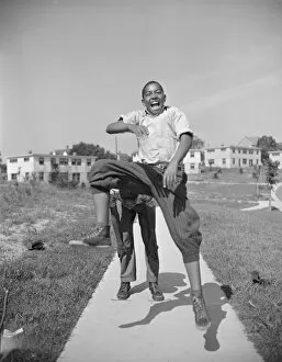 Safety Film Negatives Gmgpc Collection: Boys playing leap frog near the project, Frederick Douglass housing project, Anacostia, D.C. 1942