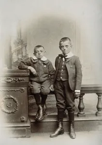 1899 Prints: Two boys, one sitting and one standing: the former appears physically deformed